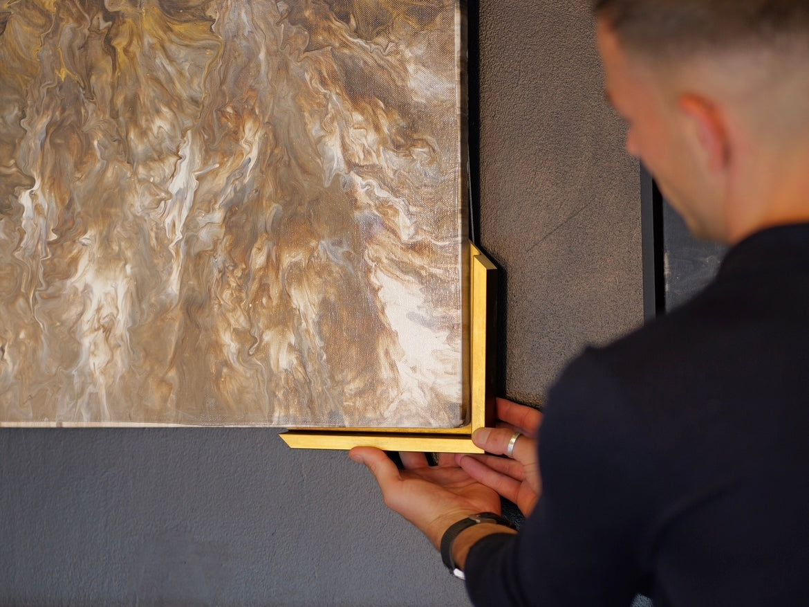 Artist holding framing to original artwork